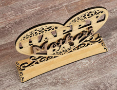 Wooden decorative item with 'Happy Dad' text on a wooden surface