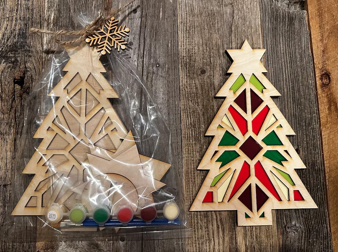 Wooden Christmas tree decoration with stained glass design on a wooden surface