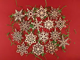 Wooden snowflake ornaments on a red background
