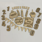 Collection of wooden birthday-themed decorations on a white background