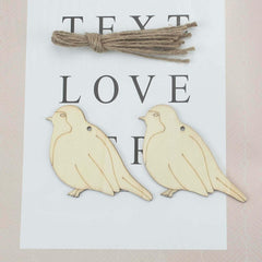 Two wooden bird shapes with twine on a card with 'TEXT LOVE' printed on it.