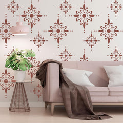 Living room with pink sofa, decorative wall patterns, and a plant.
