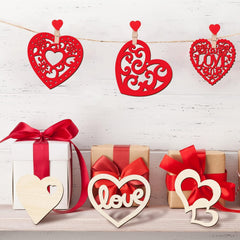 Decorative red hearts with 'love' on a white wooden background