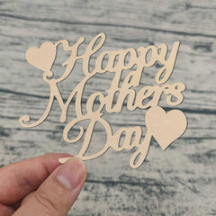 Wooden 'Happy Mother's Day' decoration held by a hand on a wooden surface