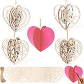 Set of wooden heart-shaped decorations with intricate cut-out designs and a pink heart in the center.