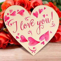 Heart-shaped card with 'I love you!' text surrounded by red roses