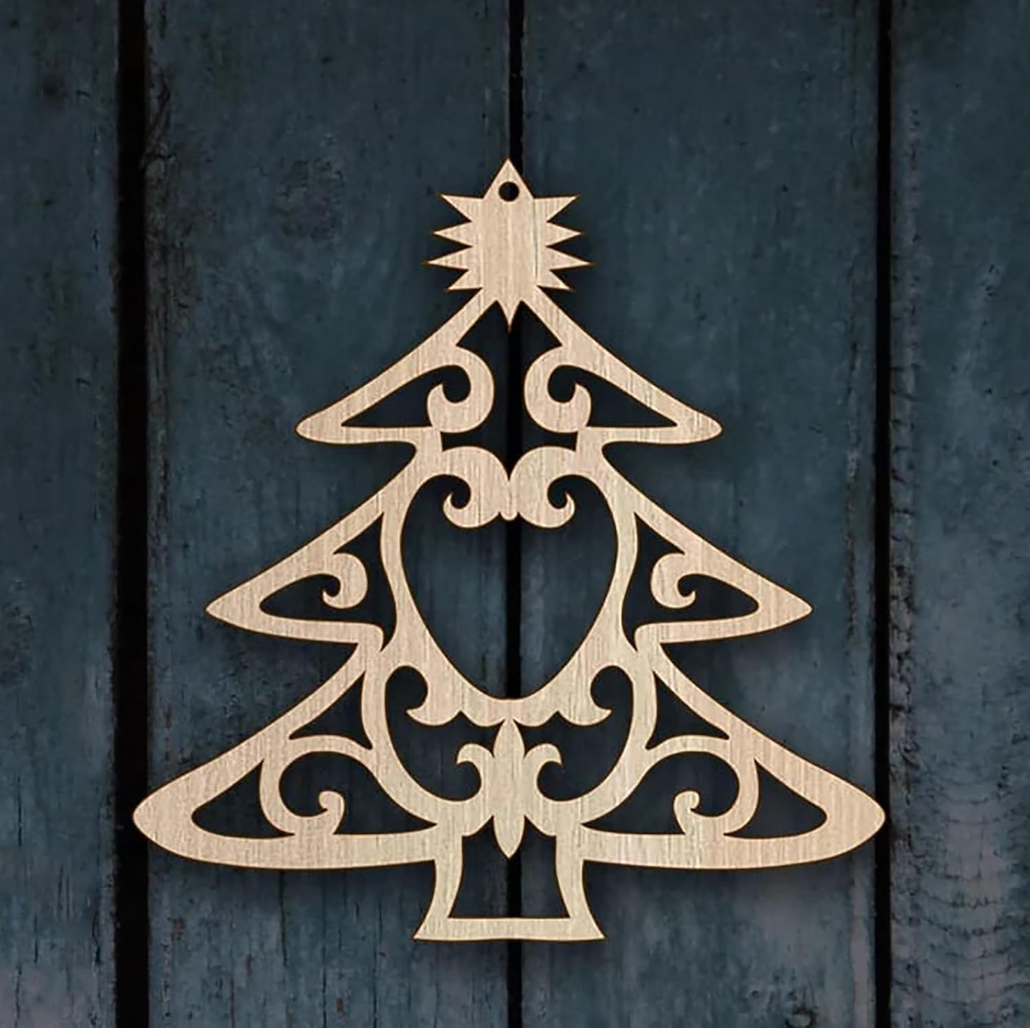 Decorative wooden Christmas tree ornament on a dark wooden background
