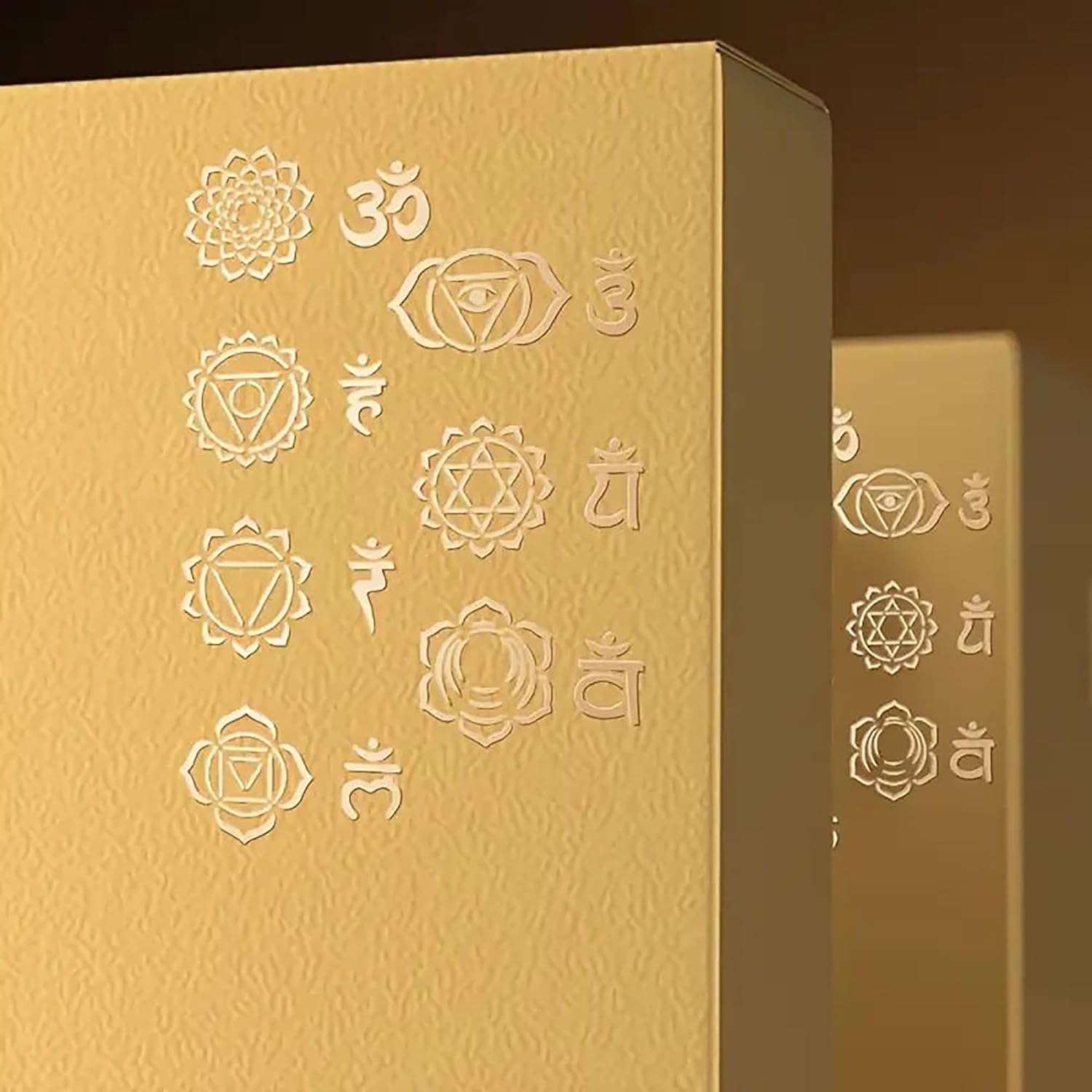 Gold box with embossed symbols on a brown background