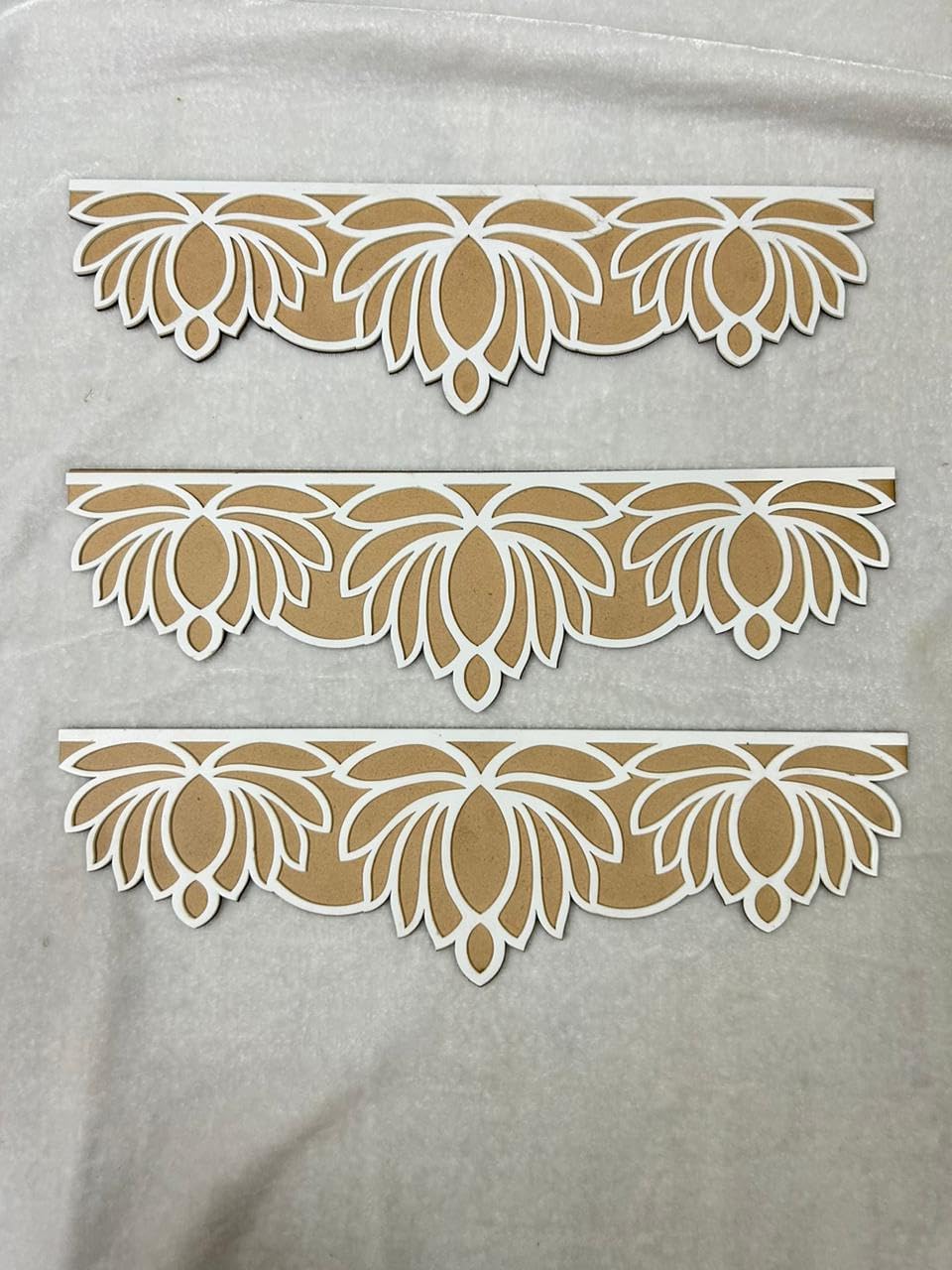 Decorative lace patterns on a gray fabric background