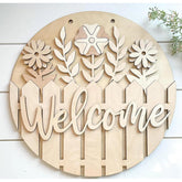 Wooden decorative sign with floral designs and the word 'Welcome' on a white background