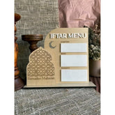 Wooden Iftar menu board with Ramadan Mubarak design on a textured surface.