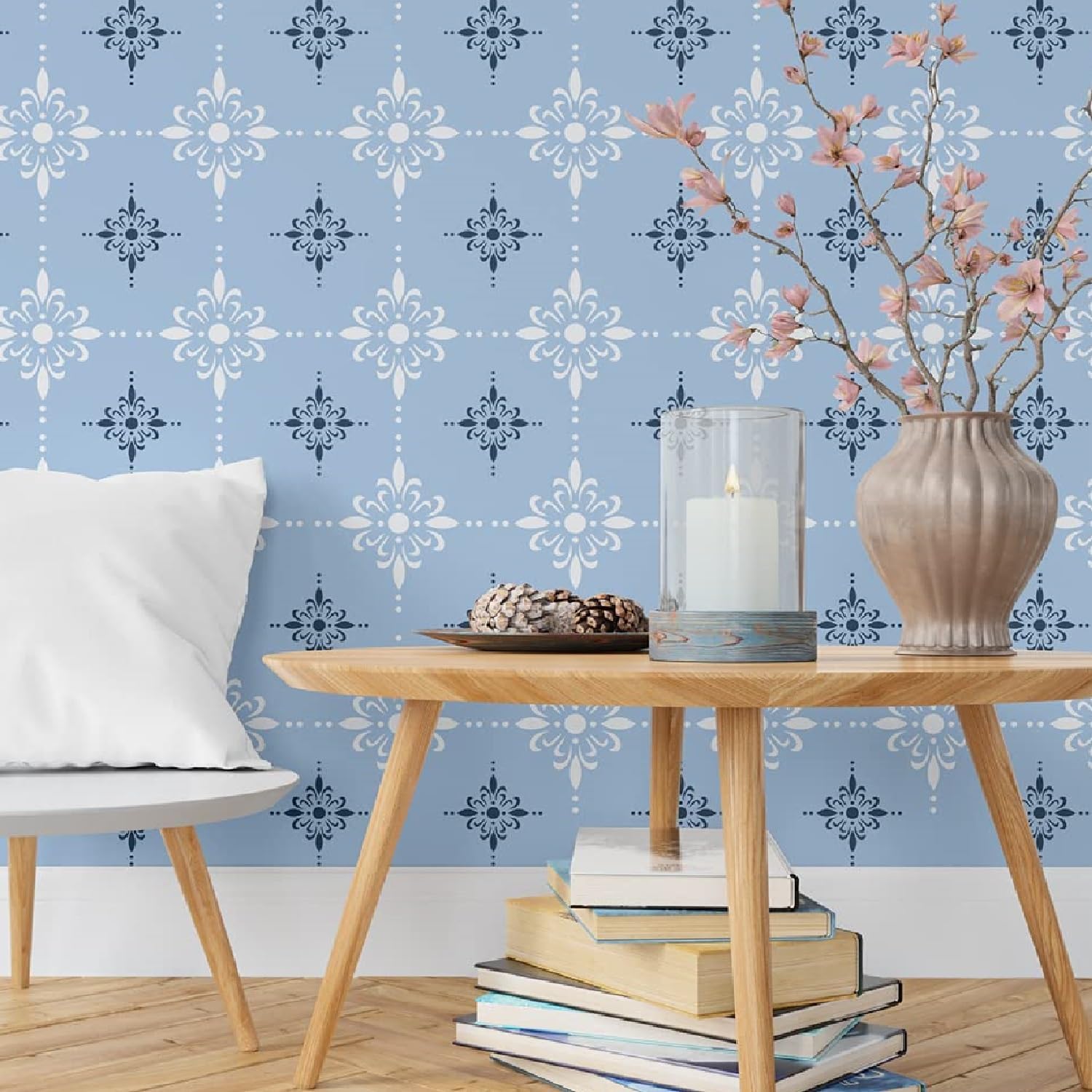 Living room with wooden table, books, and decorative items against a blue patterned wall.