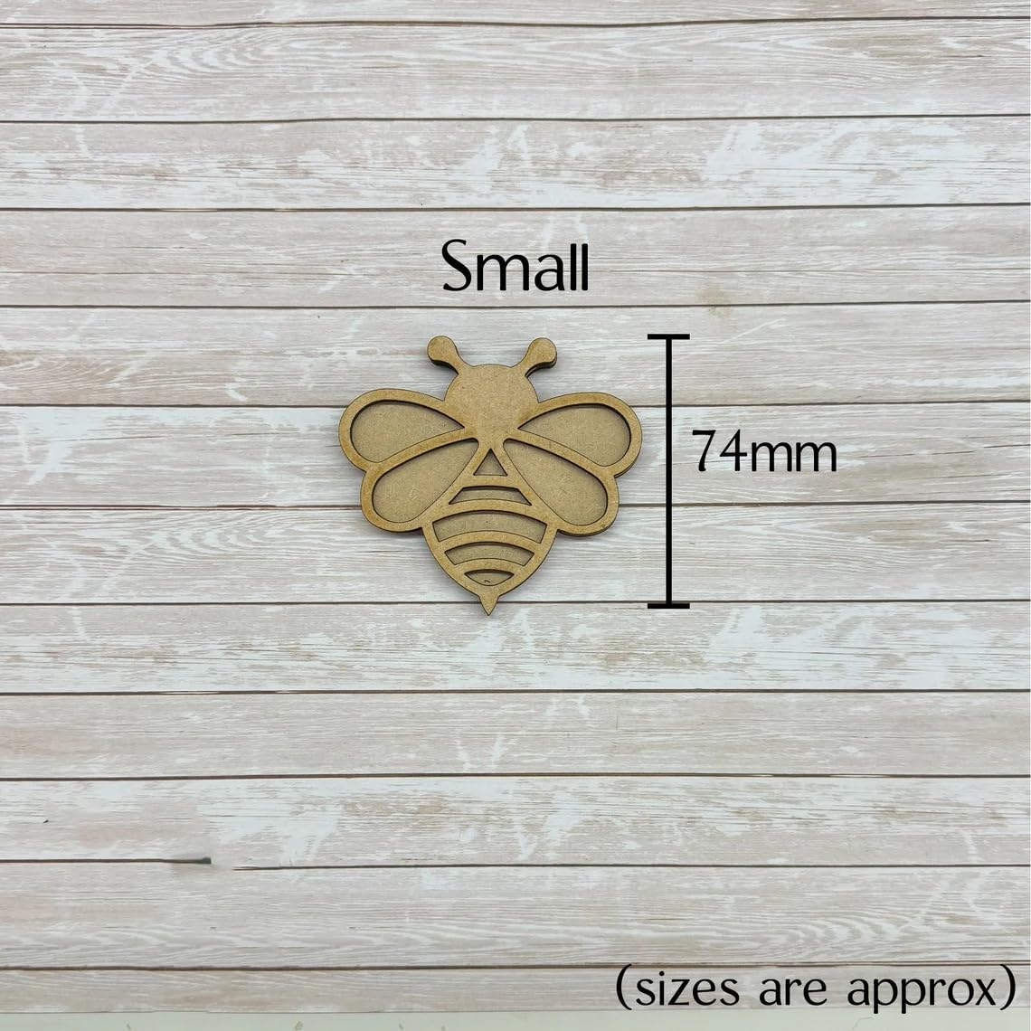 Wooden bee-shaped cutout with dimensions on a wooden background
