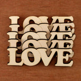 Wooden letters spelling 'LOVE' on a wooden background