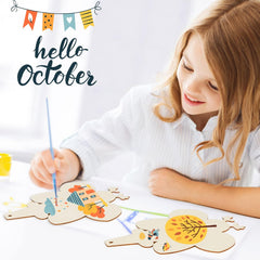 Child painting wooden crafts with 'hello October' text and colorful flags in the background
