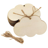 Set of cloud-shaped wooden tags with twine on a white background