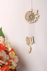 Wooden dreamcatcher with feathers and flowers on a white background