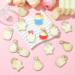 Decorative bottle-shaped charms on a pink background with flowers.