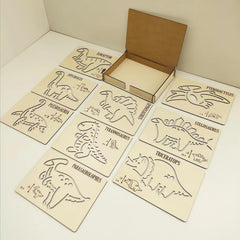 Set of dinosaur-themed wooden cutouts with a cardboard box on a beige background