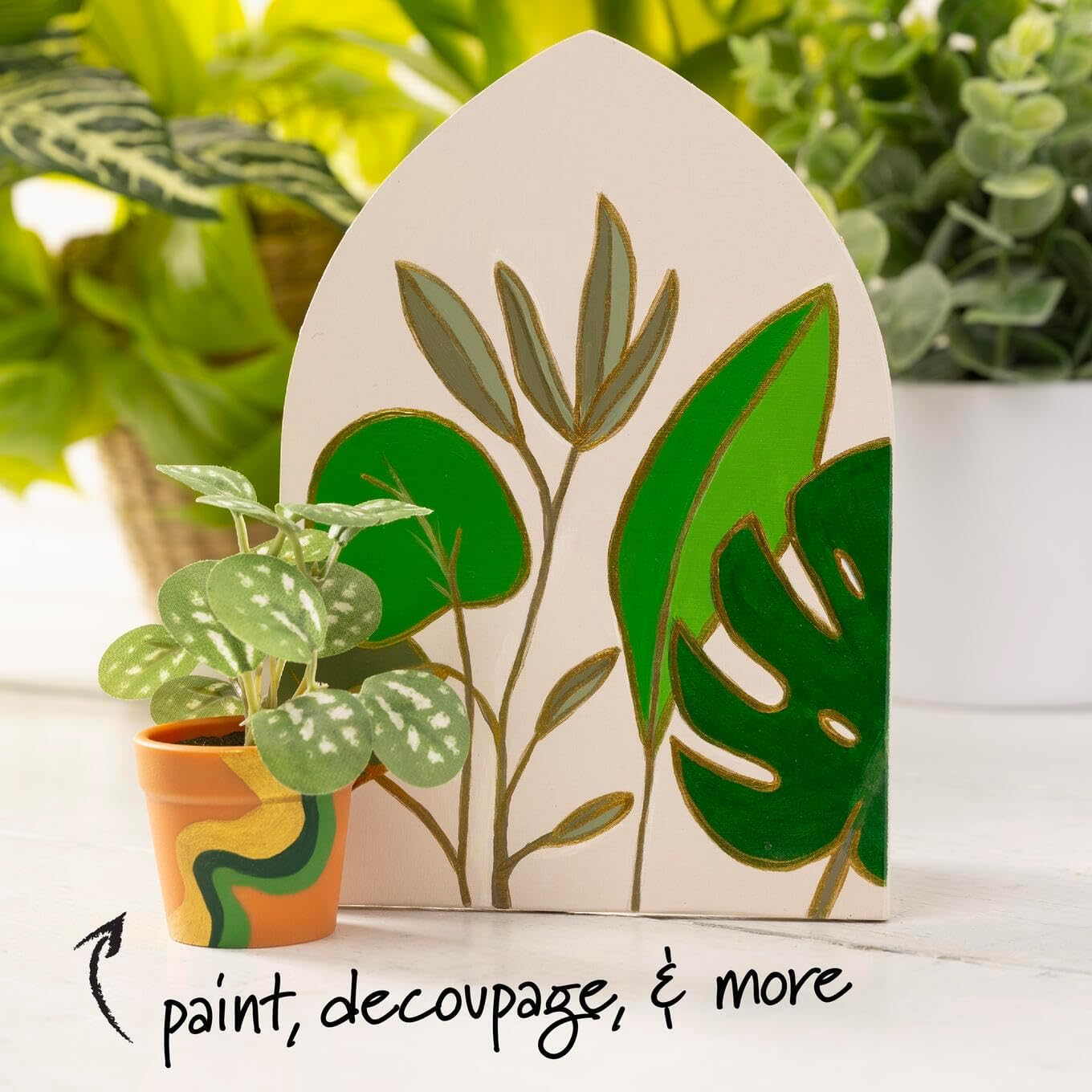 Decorative plant-themed card with green leaves and a small potted plant on a white surface.