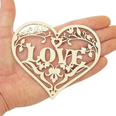Decorative heart-shaped cutout with 'LOVE' in the center held in a hand against a white background