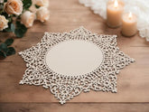Decorative lace doily on a wooden table with candles and flowers in the background