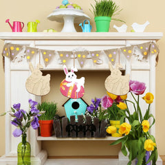 Decorative Easter mantel with bunting, birdhouse, and flowers on a fireplace.