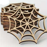 Wooden coasters with spider web design on a white background