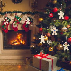 Decorated Christmas tree with stockings and a fireplace in the background