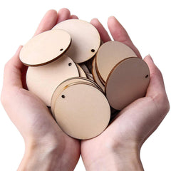 Hands holding a pile of round wooden cutouts on a white background