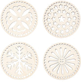 Four wooden coasters with decorative cut-out patterns on a white background