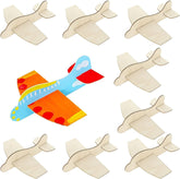 Colorful toy airplane with beige cut-out airplane shapes on a white background