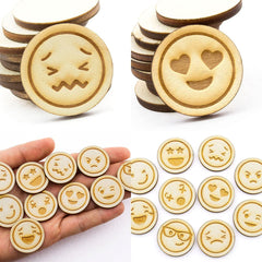 Wooden emoji coasters with various designs held in a hand, surrounded by additional coasters on a white background.