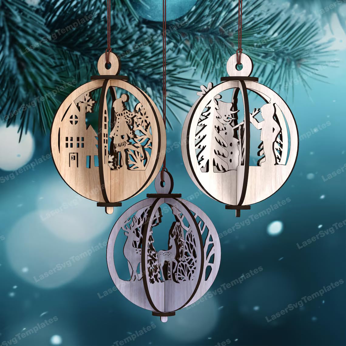 Three wooden Christmas ornaments with laser-cut designs of a nativity scene on a blue snowy background.