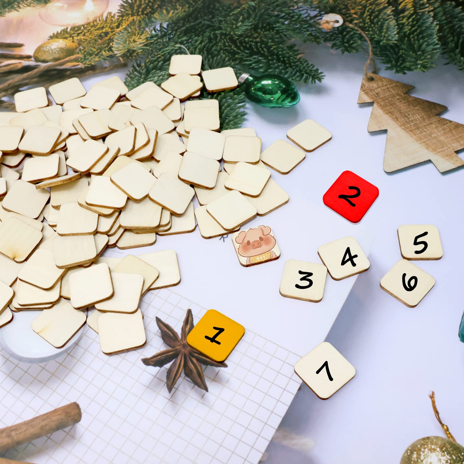 Wooden square tiles with numbers and Christmas decorations on a white surface