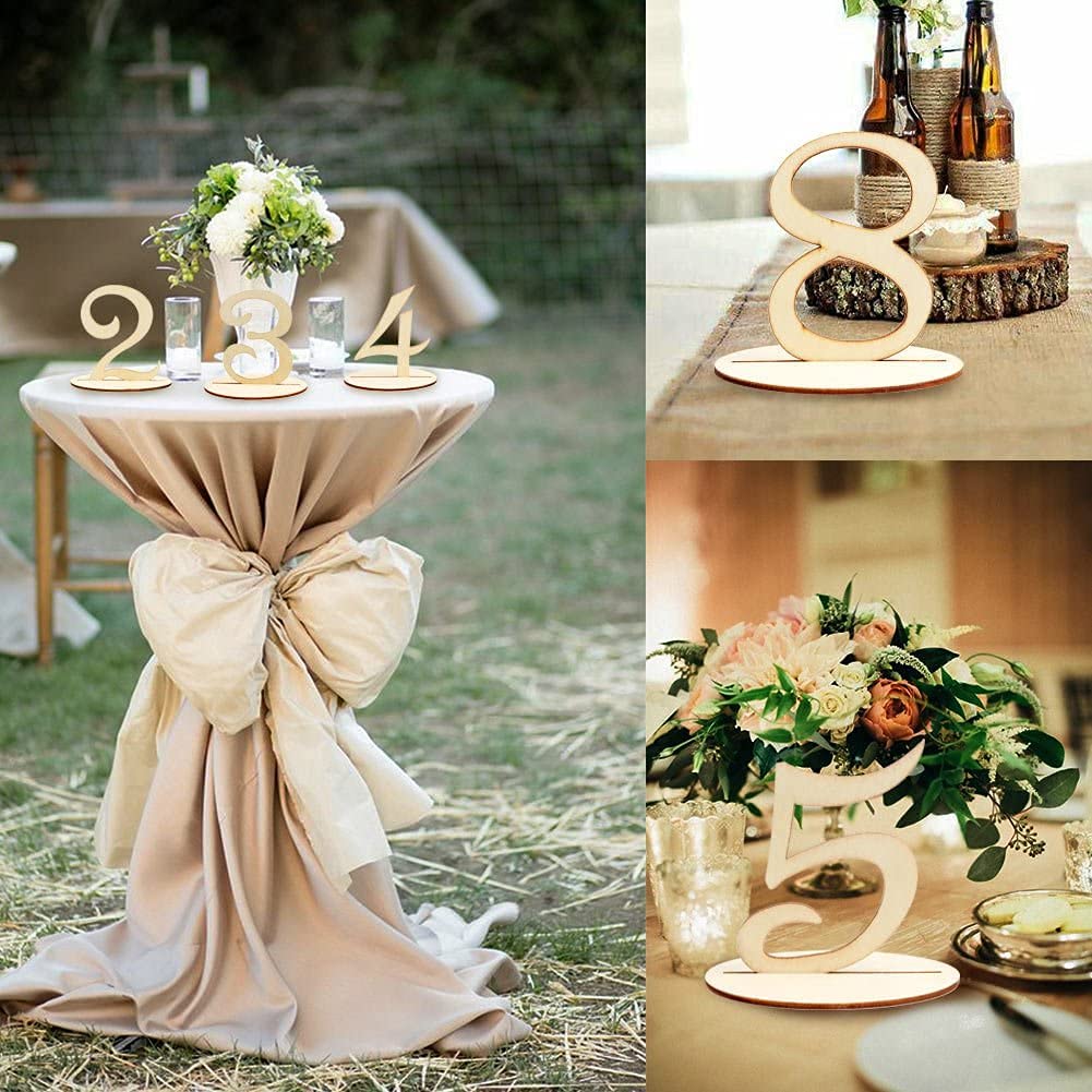 Decorative table setup with floral arrangements and table numbers outdoors.