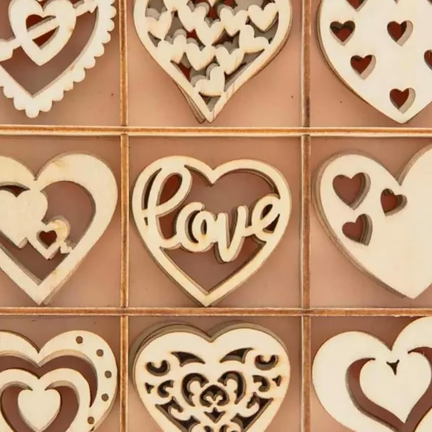Wooden heart-shaped decorations with cut-out designs on a brown background