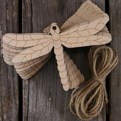 Wooden dragonfly decoration with twine on a wooden background