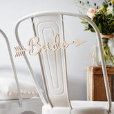 Wooden 'Bride' sign on a white chair with a blurred background