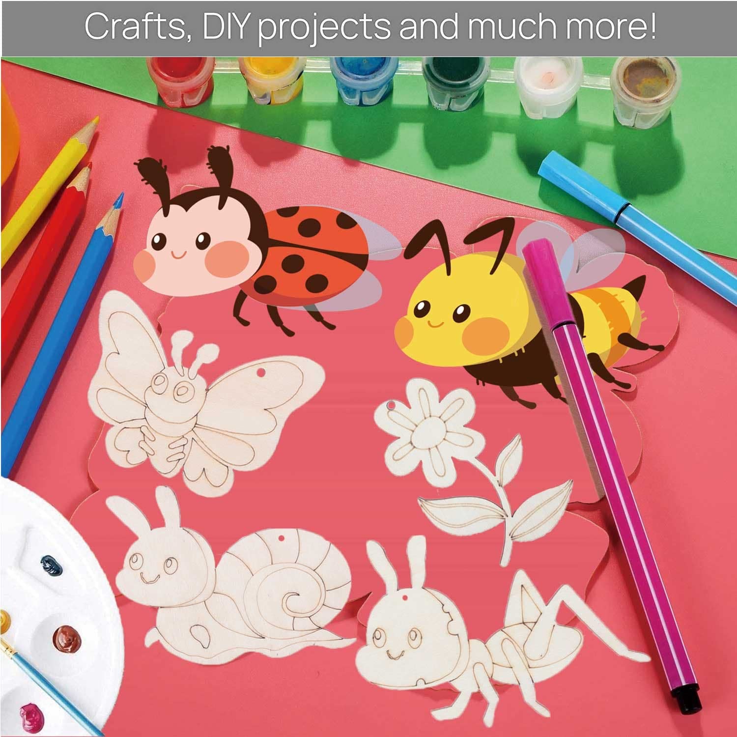 Colorful craft materials with cartoon insects and flowers on a pink surface.