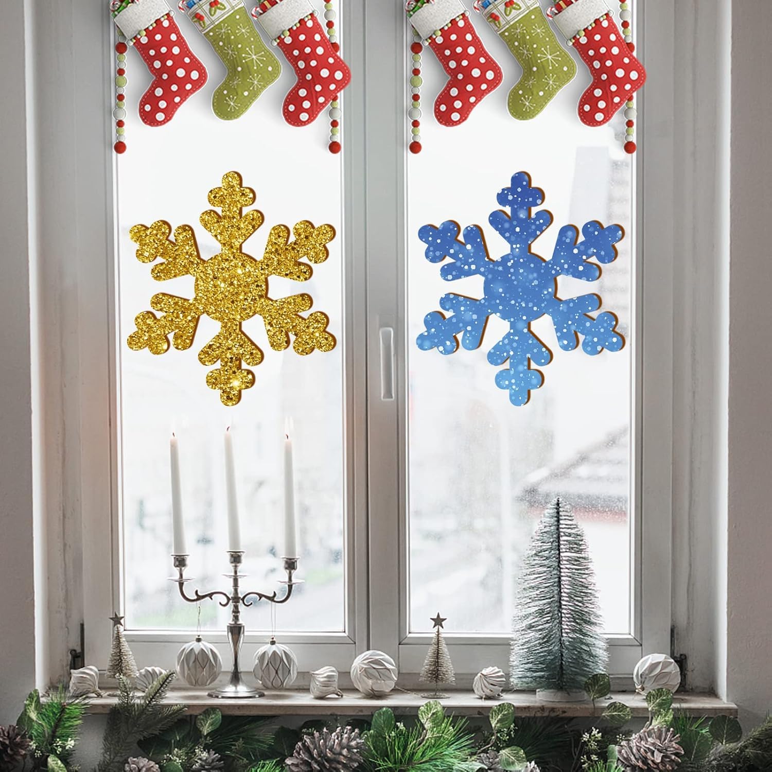 Decorative window with gold and blue snowflakes, stockings, and Christmas decor.