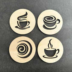 Four wooden coasters with coffee cup designs on a dark surface