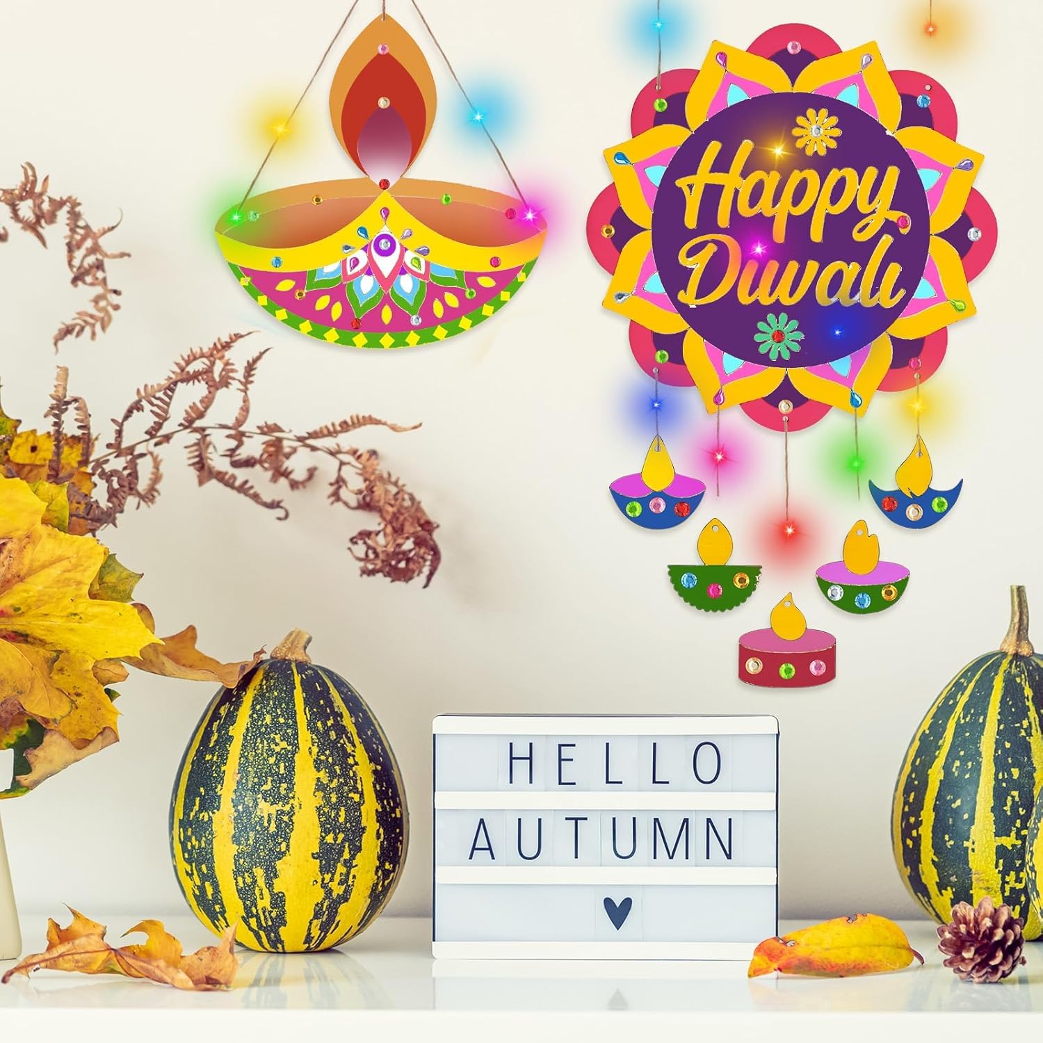 Decorative items for Diwali with colorful lights and 'Happy Diwali' sign, surrounded by autumn-themed elements.