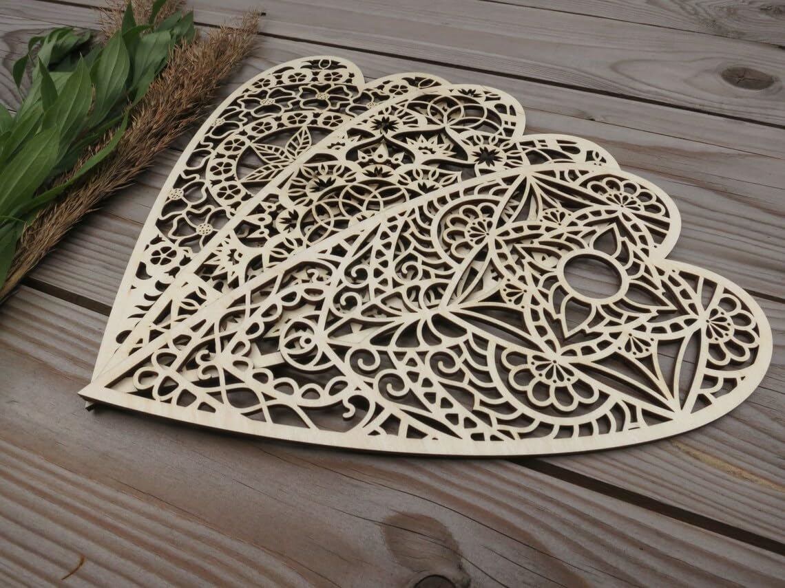 Decorative wooden heart-shaped cutout on a wooden surface with leaves and twigs.