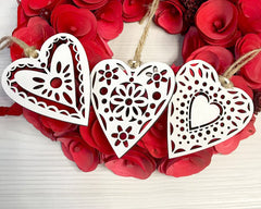 Decorative heart-shaped ornaments on a red floral background