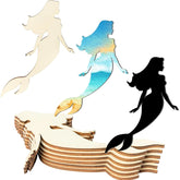Set of mermaid-shaped wooden cutouts in various colors on a white background