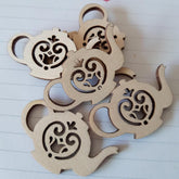 Wooden monkey shapes with cut-out designs on a white background