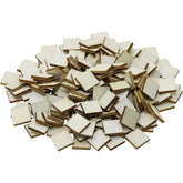 Pile of small wooden squares with gold accents on a white background