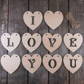 Wooden heart-shaped letters spelling 'I LOVE YOU' on a wooden background