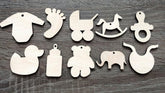 Set of wooden baby-themed ornaments on a wooden surface